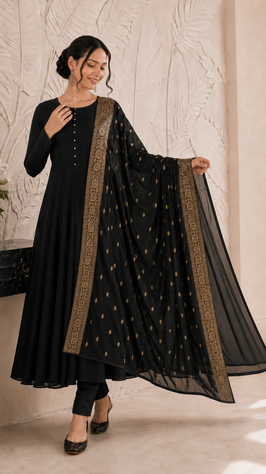 Woman wearing a black Anarkali suit with gold embroidered dupatta and trousers – Diya Online ethnic wear.