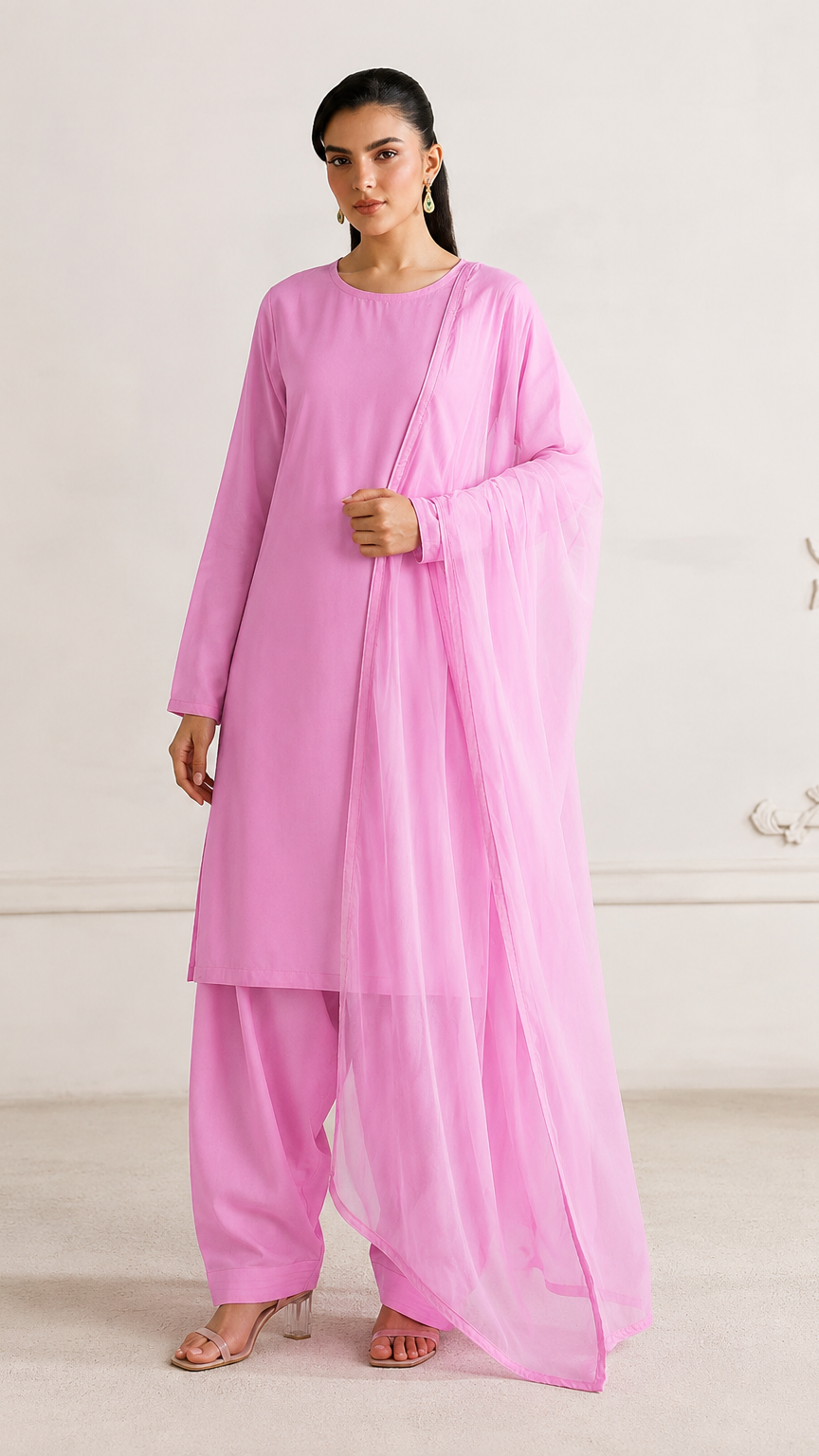 Buy bright pink plain Pakistani salwar kameez with long kurta, gathered trousers and matching sheer dupatta for women online at Diya Online