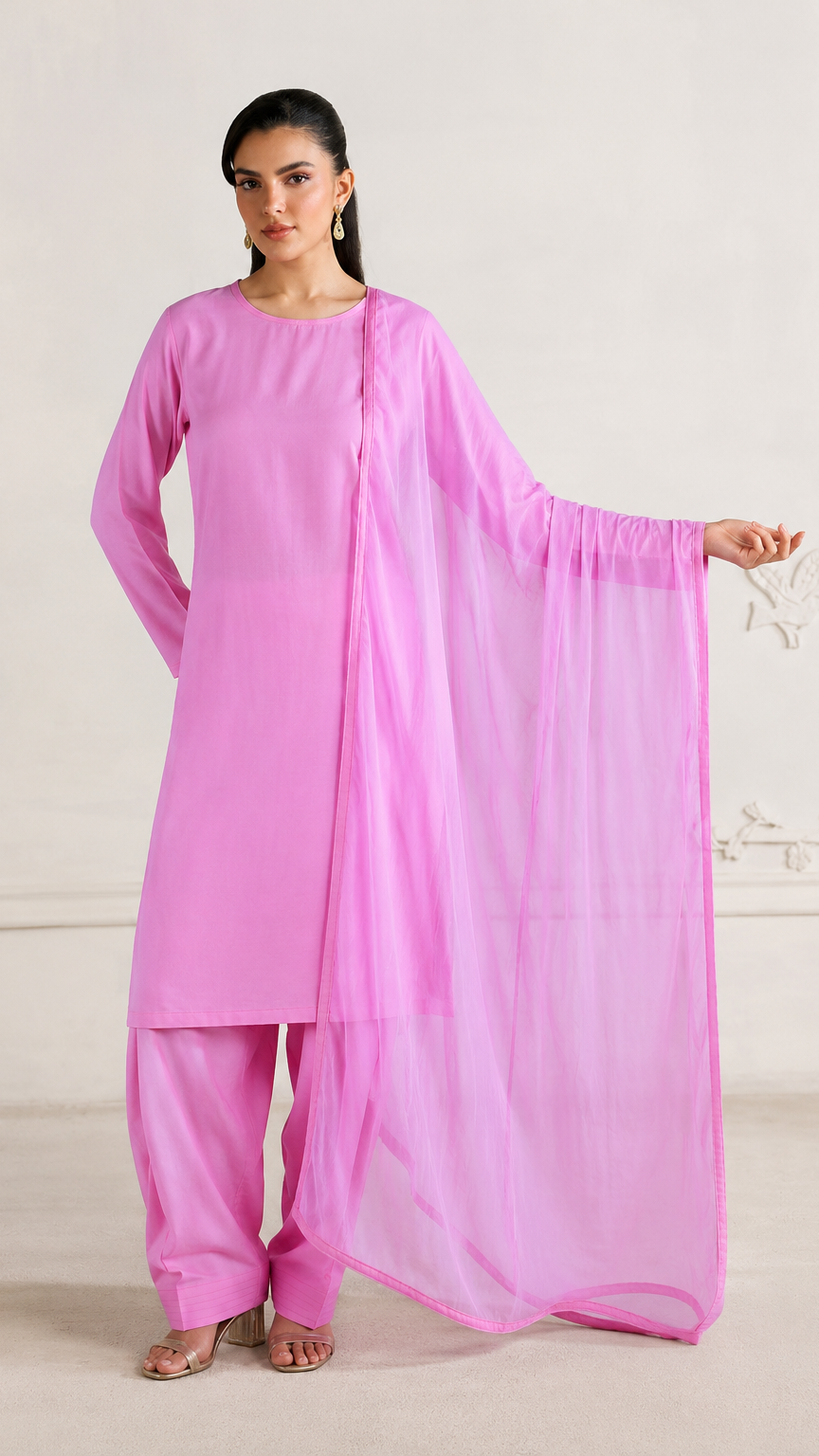 Buy bright pink plain Pakistani salwar kameez with long kurta, gathered trousers and matching sheer dupatta for women online at Diya Online