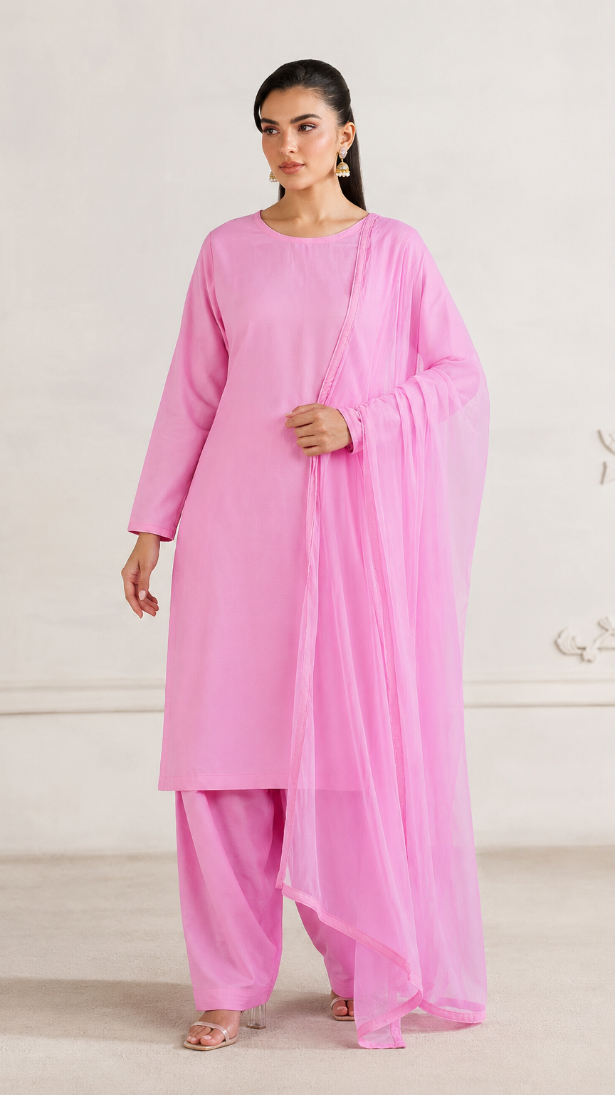 Buy bright pink plain Pakistani salwar kameez with long kurta, gathered trousers and matching sheer dupatta for women online at Diya Online