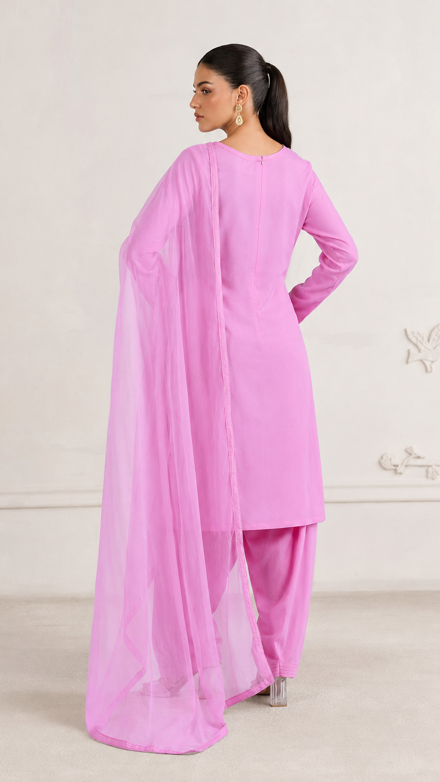 Buy bright pink plain Pakistani salwar kameez with long kurta, gathered trousers and matching sheer dupatta for women online at Diya Online