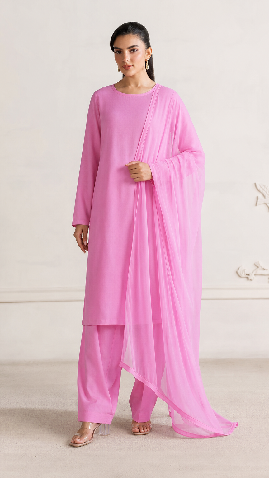Buy bright pink plain Pakistani salwar kameez with long kurta, gathered trousers and matching sheer dupatta for women online at Diya Online