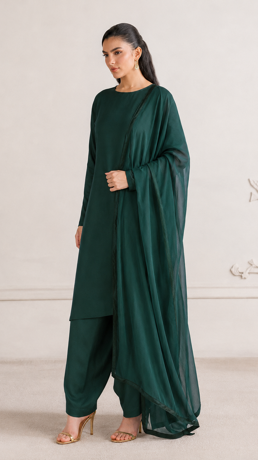 Buy plain dark emerald green Pakistani salwar kameez with long kurta, gathered trousers and matching sheer dupatta for women online at Diya Online.