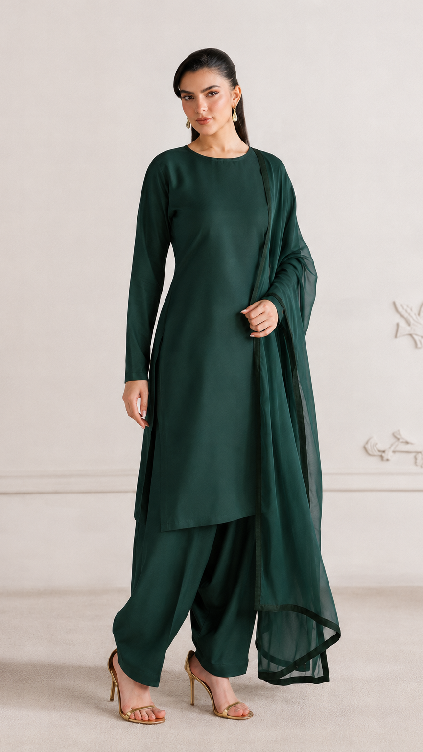 Buy plain dark emerald green Pakistani salwar kameez with long kurta, gathered trousers and matching sheer dupatta for women online at Diya Online.