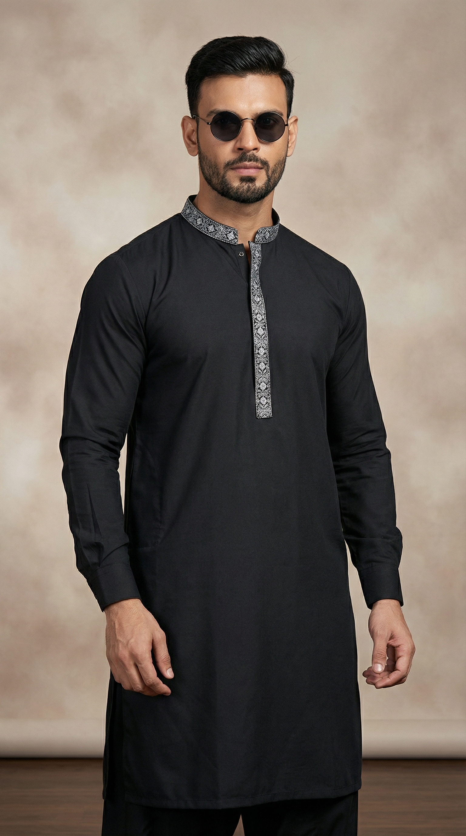 Men’s black embroidered shalwar kameez featuring premium fabric kameez with contrast embroidered neckline and matching shalwar, traditional ethnic wear for Eid, weddings, festive and formal occasions.