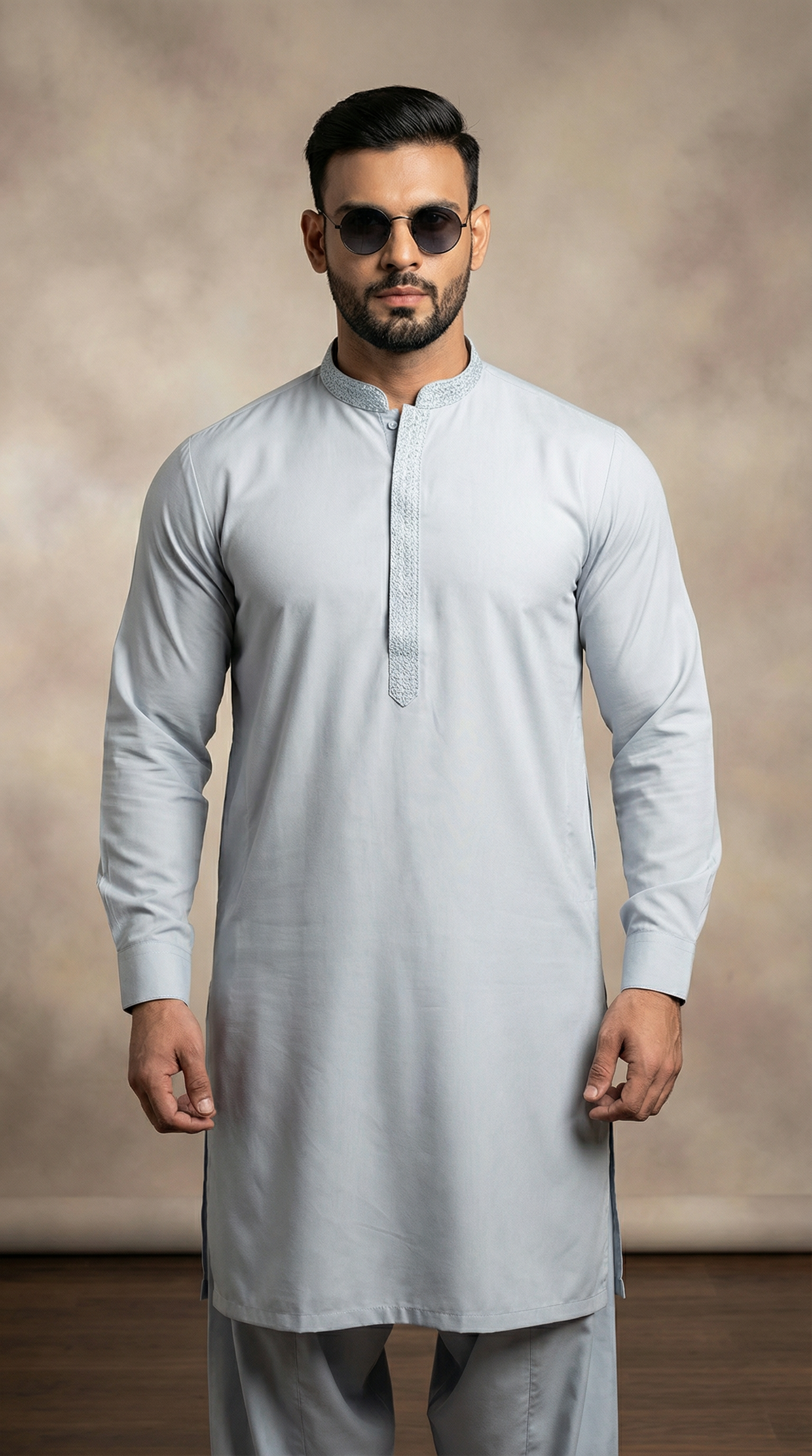 Light blue men’s shalwar kameez featuring embroidered placket and loose fit trousers, traditional South Asian outfit